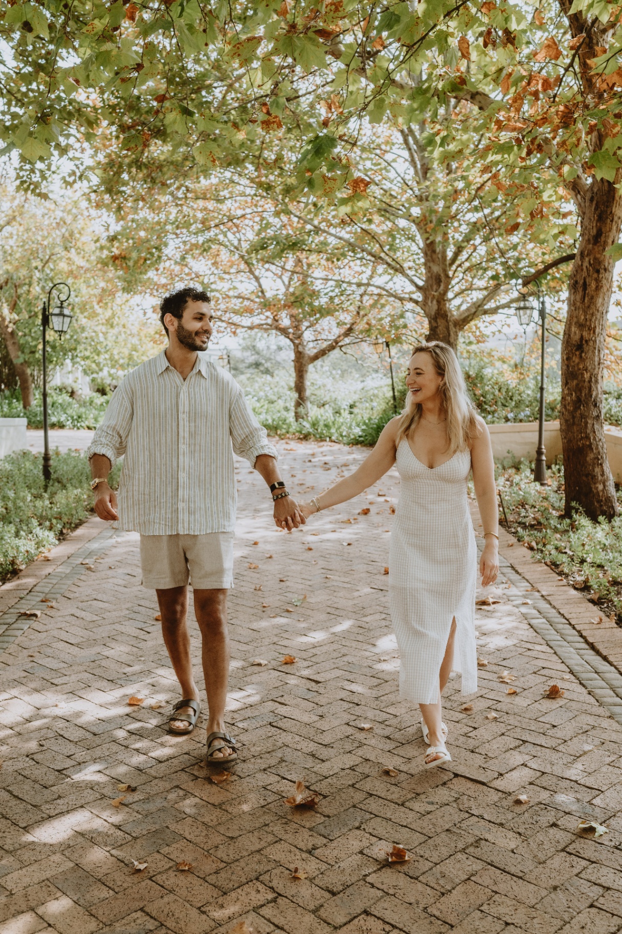 Godfrey and Tara walking under the trees