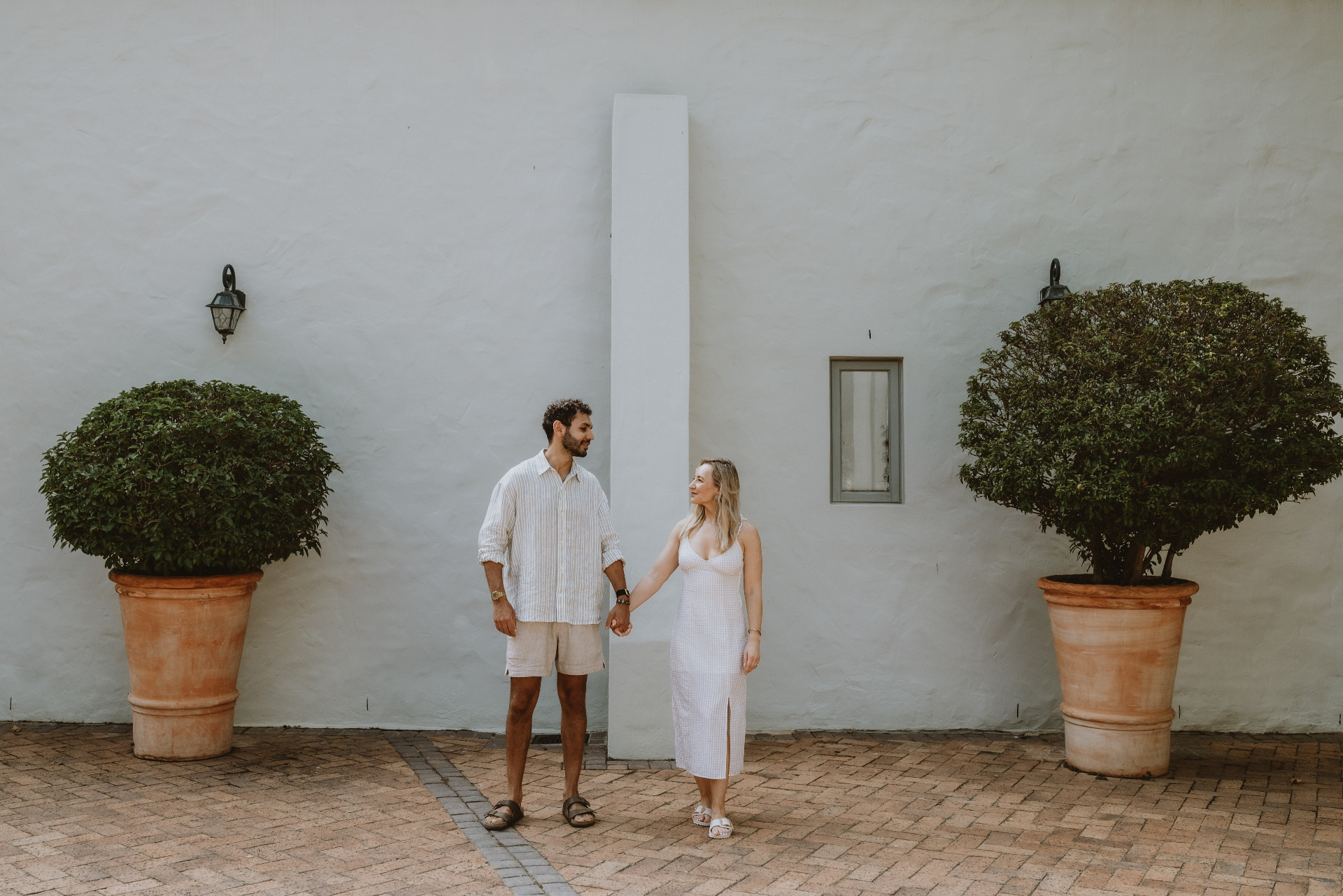 Godfrey and Tara by white wall